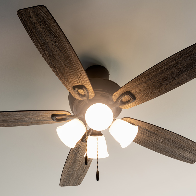Residential ceiling fan in motion on a white ceiling