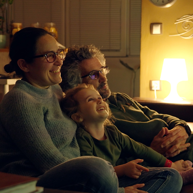 Family on Couch Watching Tv