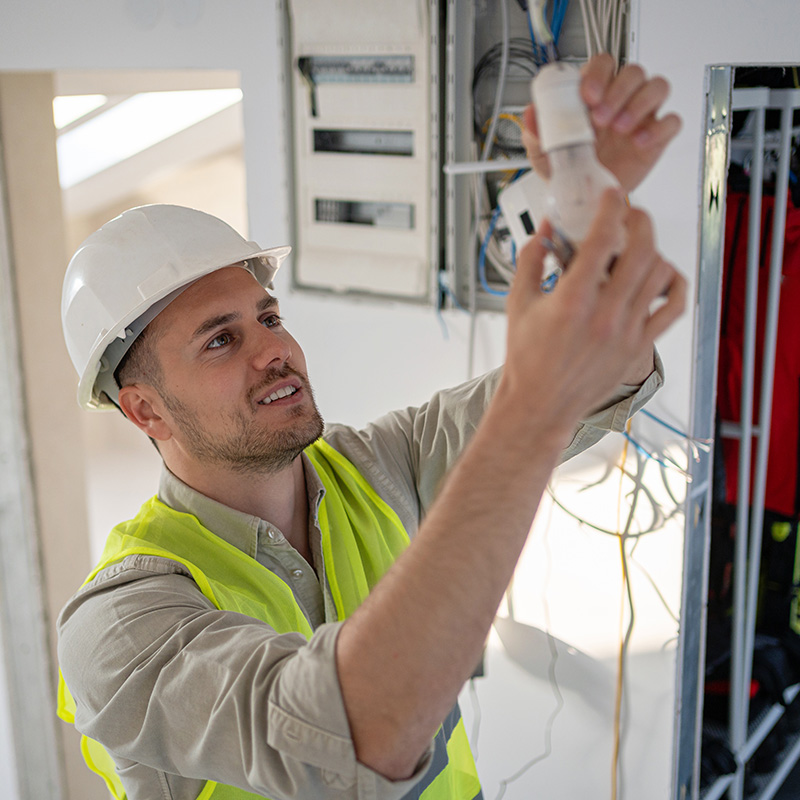 electrician using his tools to connect the installations and light up the space safely